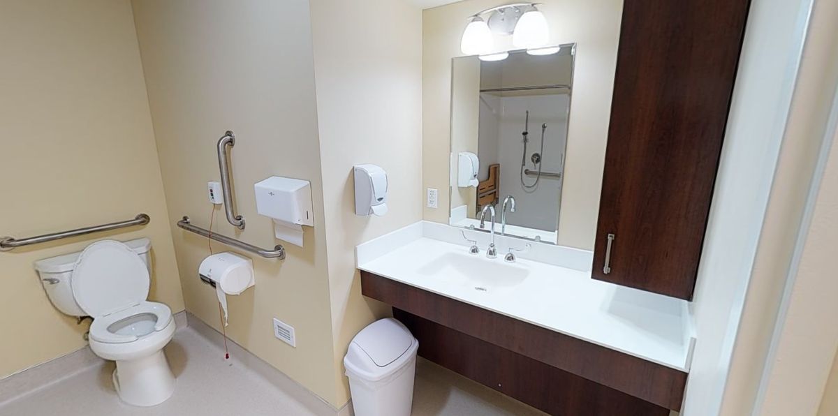 A clean, well-lit bathroom with a sink and mirror.