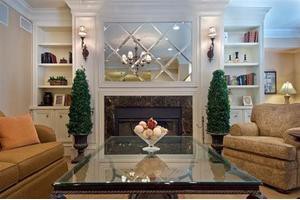 Elegant living room with a mirrored wall and cozy fireplace.