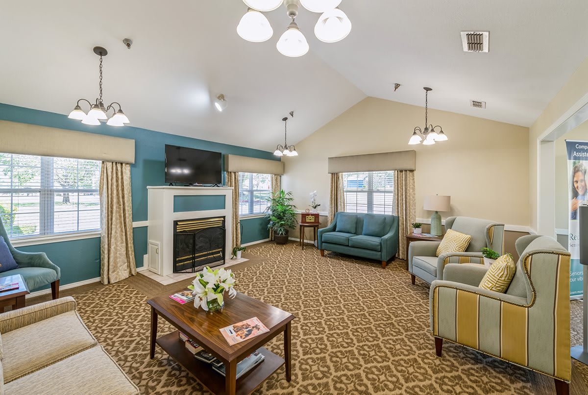 Cozy living room with comfortable seating, a fireplace, and a television.