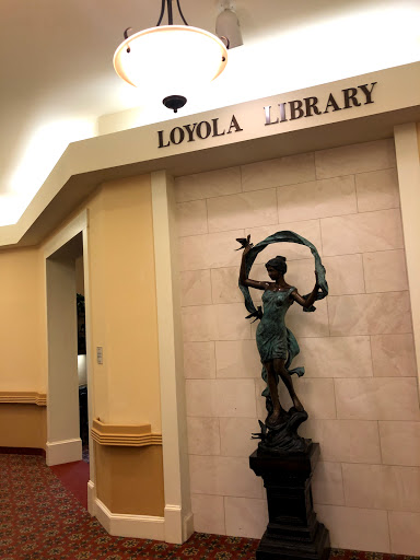 Entrance to the Loyola Library featuring a decorative statue.