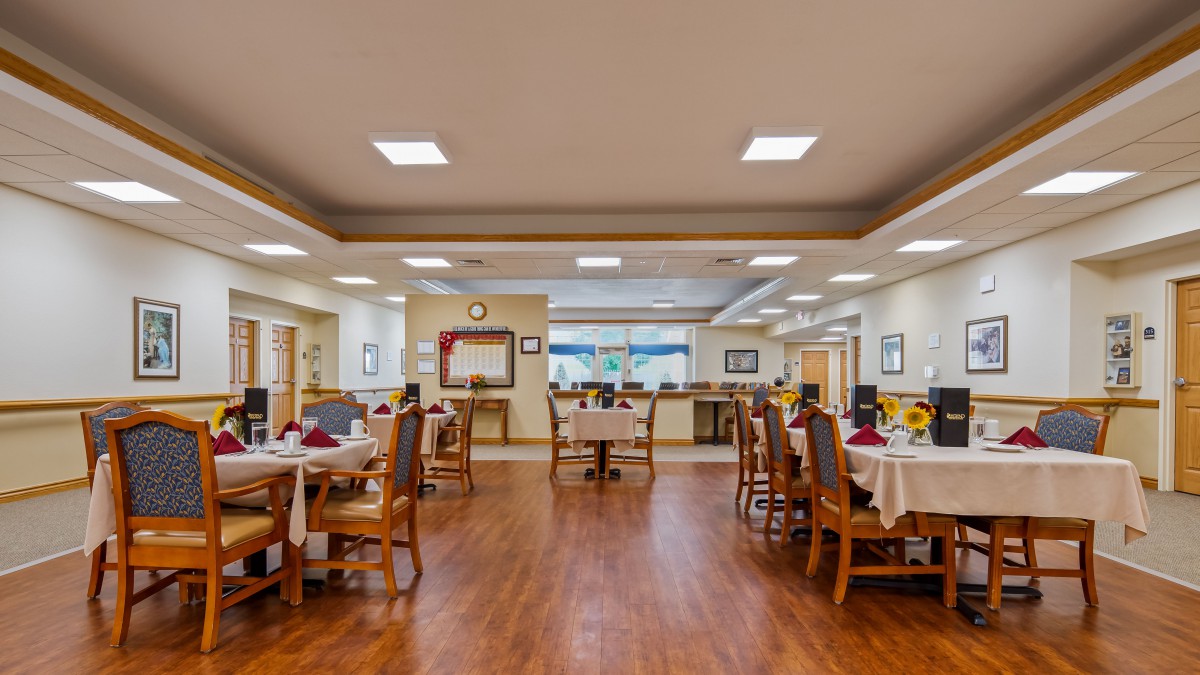 A spacious and elegantly decorated dining area with neatly arranged tables and chairs.