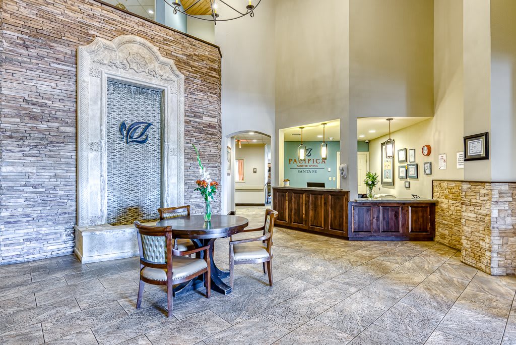 A modern lobby with a reception desk and seating area.