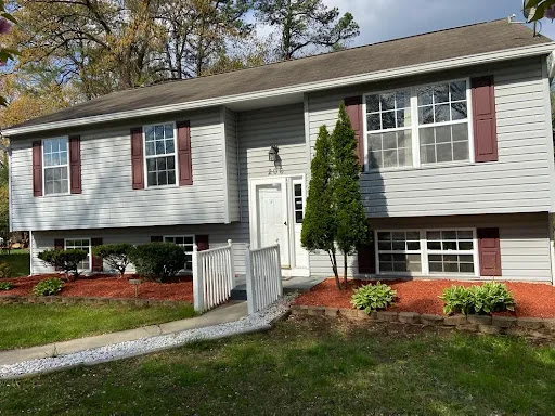 A charming split-level house with a welcoming front yard and neatly landscaped garden.