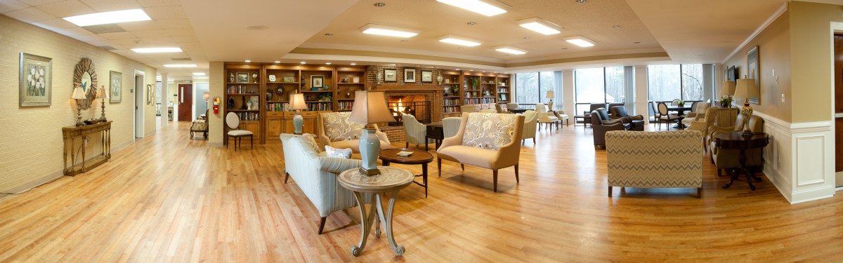 A cozy lounge area with comfortable seating and a warm fireplace.