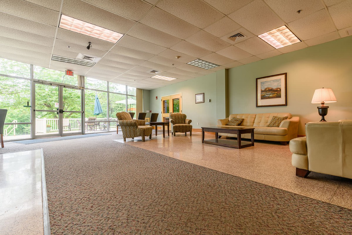 A spacious and well-lit lobby with comfortable seating and large windows.