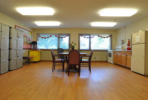 A spacious and well-lit kitchen/dining area featuring a round table and chairs.