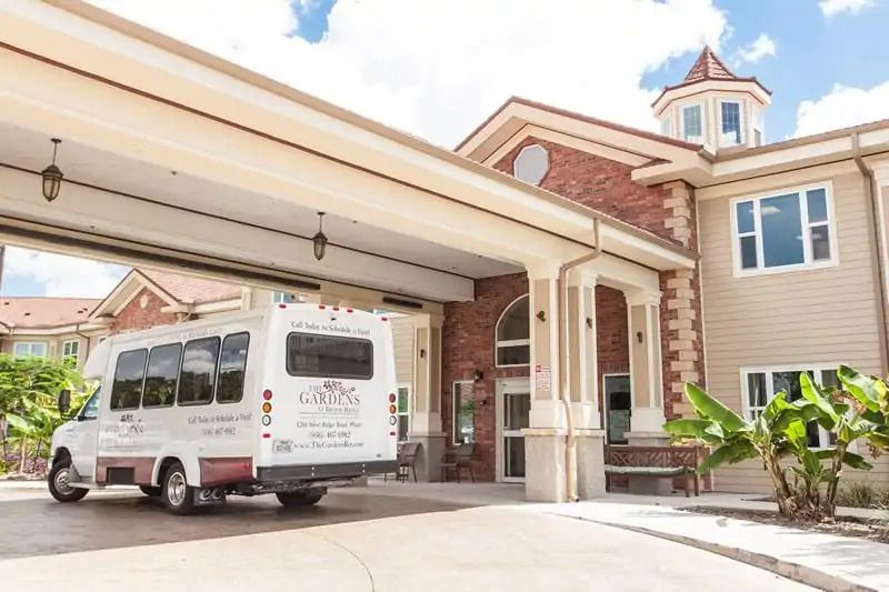 A hotel's shuttle bus parked at the main entrance.