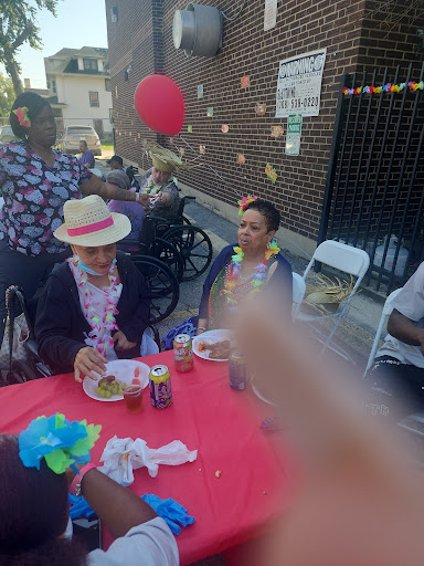 A joyful outdoor celebration with community members enjoying food and festivities.