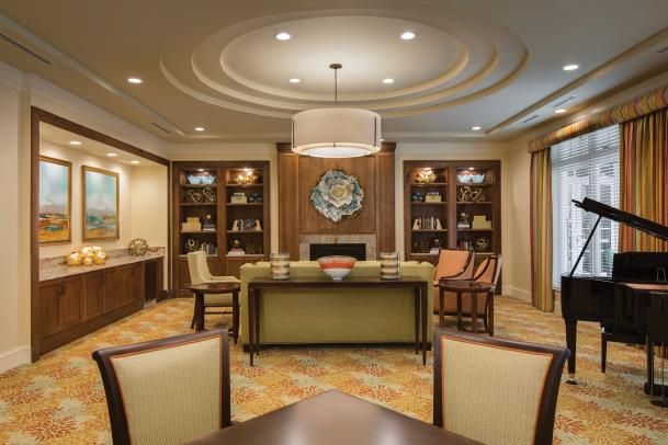 A luxurious and elegantly designed living room with comfortable seating, stylish bookshelves, and ambient lighting.
