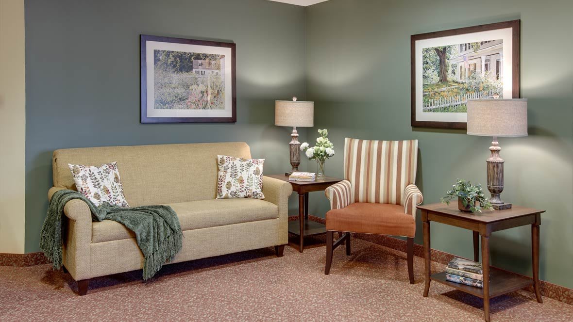 Cozy living room with a couch, armchair, and decorative elements.