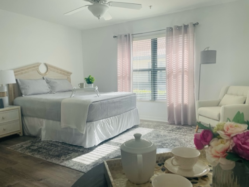 A serene and cozy bedroom featuring soft colors, natural light, and inviting decor.