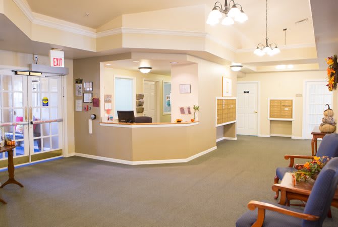 A well-lit reception area with a waiting room and seating.