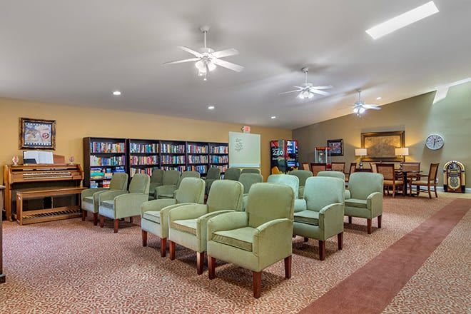 A spacious library with comfortable seating and well-stocked bookshelves.