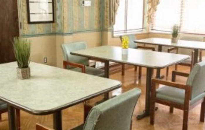 Empty dining room with tables and chairs.