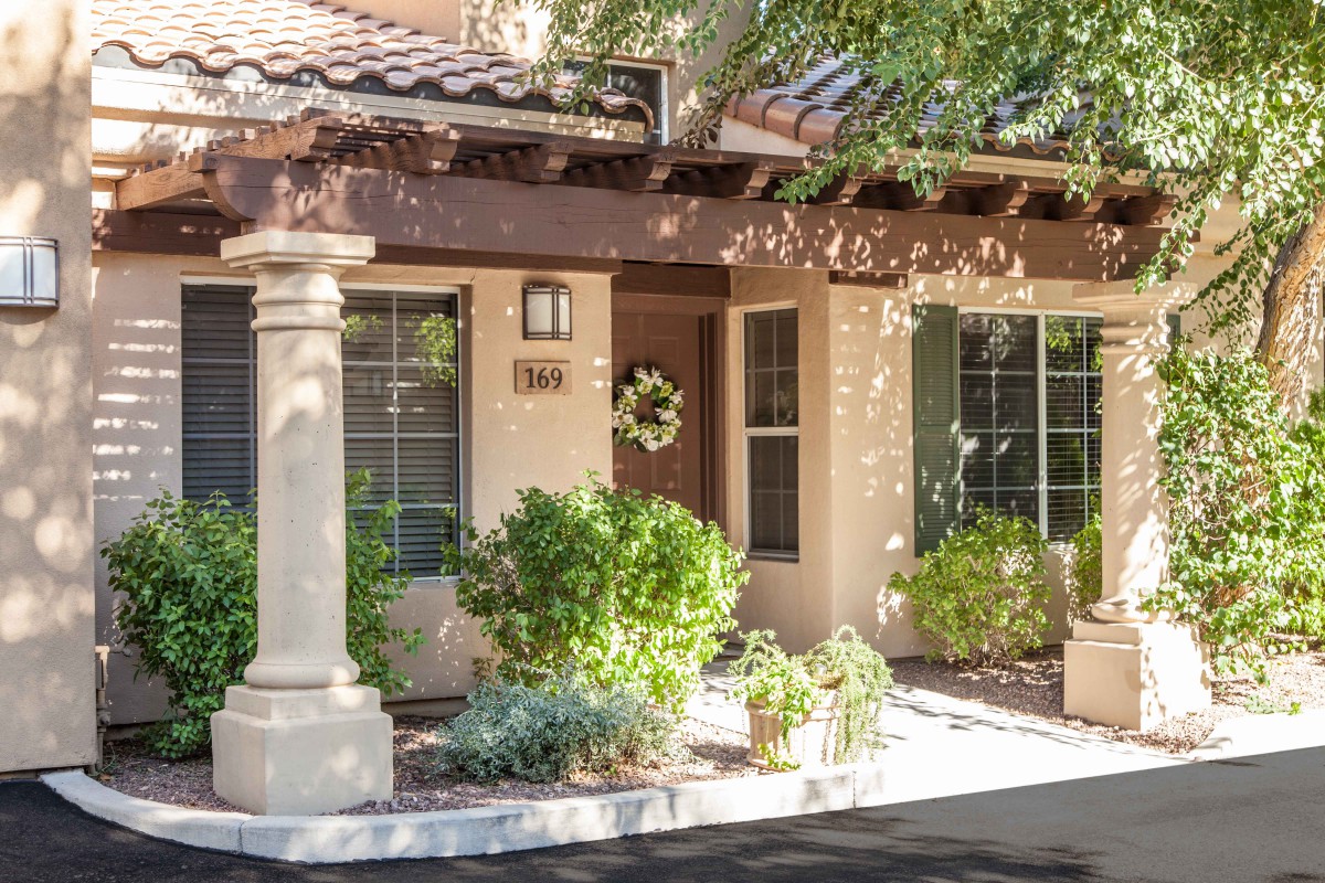 A cozy house exterior surrounded by greenery and a welcoming entrance.