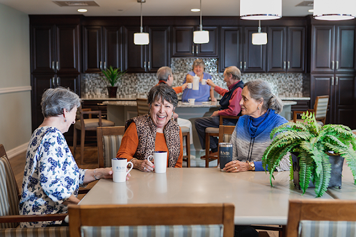 A vibrant senior living community where residents enjoy each other's company over coffee.