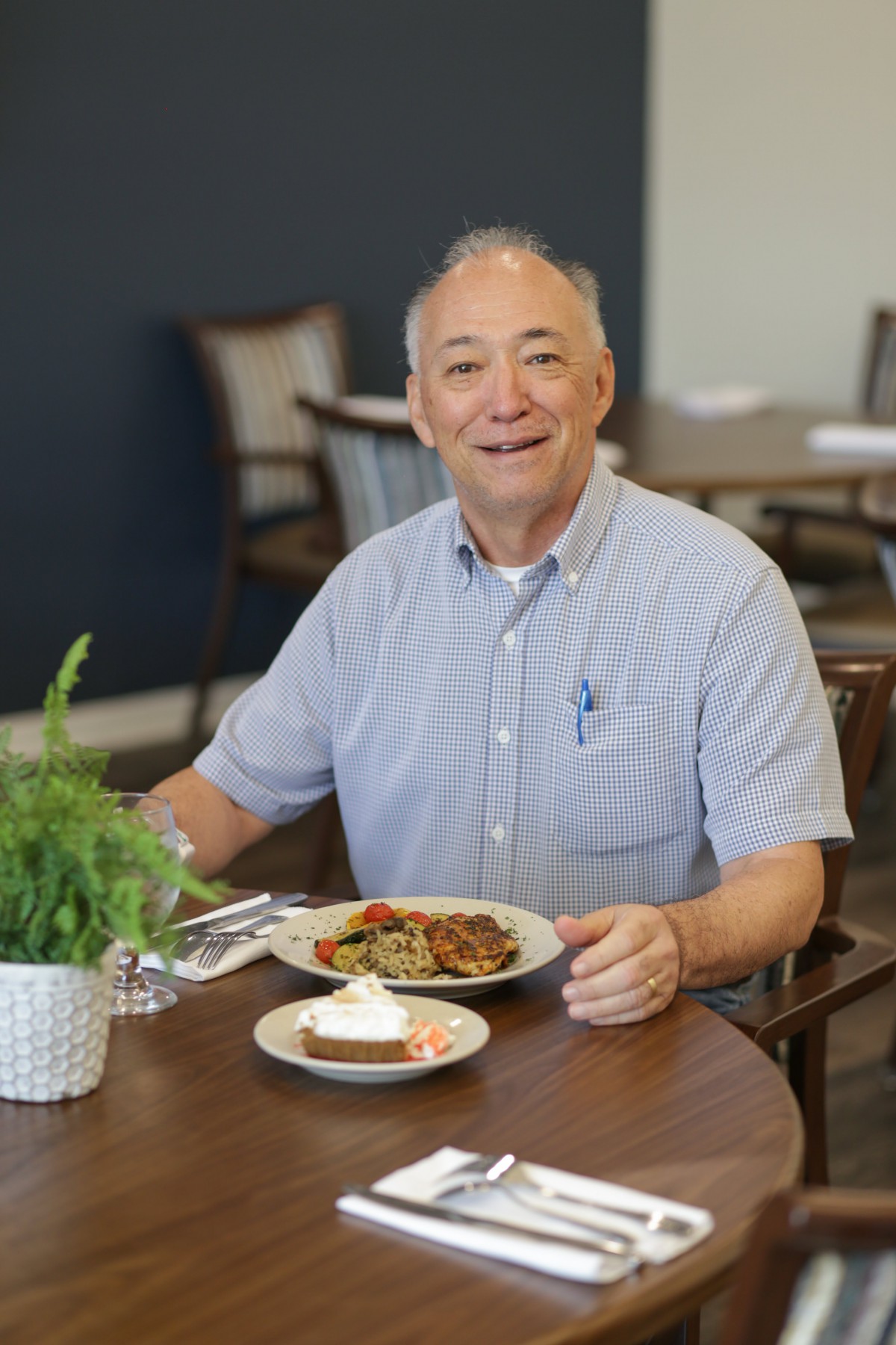 A man enjoying a meal at a restaurant table.