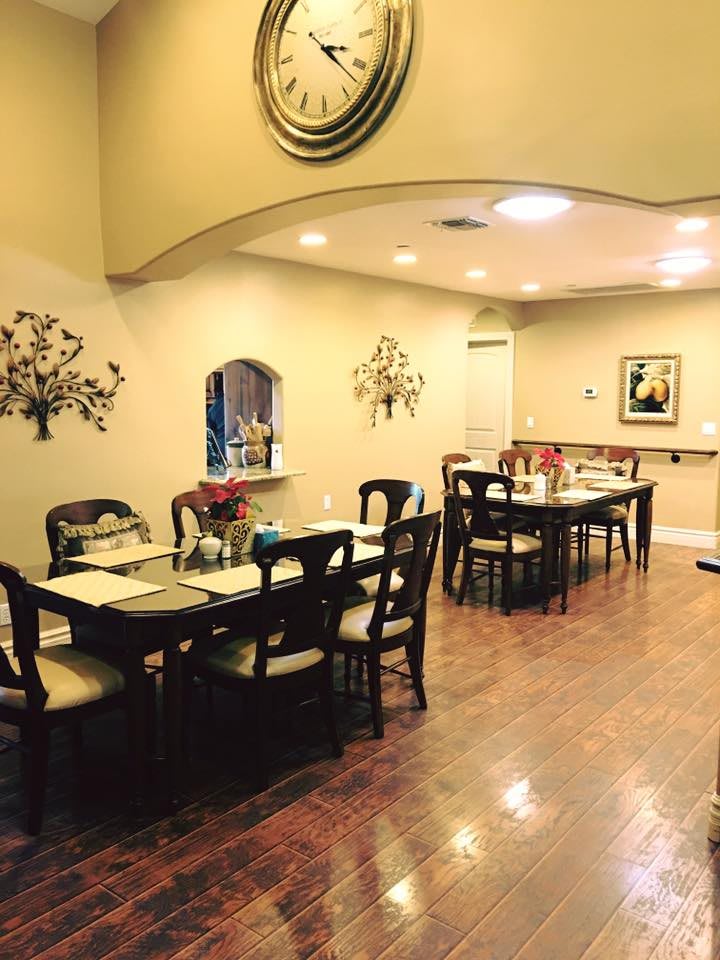 A cozy dining area with neatly arranged tables and chairs, adorned with elegant decor.