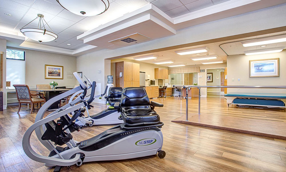 A modern gym with stationary bikes and exercise equipment in a well-lit room.