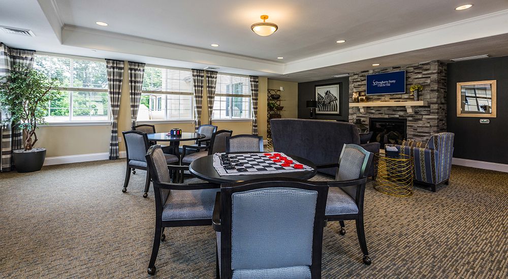 A cozy living room with a game table and comfortable seating.