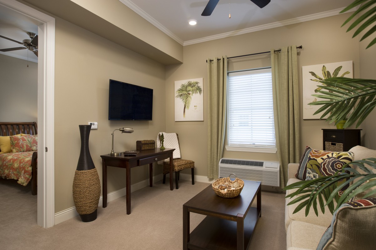 A modern living room with a television, artwork, and stylish furniture.