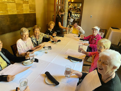 A cheerful gathering of seniors enjoying a meal together at a restaurant.