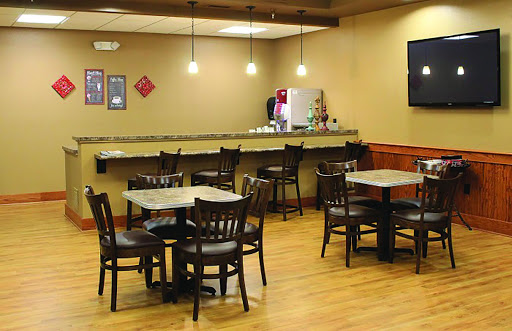 A cozy dining area with wooden tables and chairs, perfect for casual meals.
