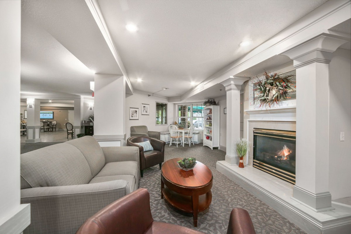 A cozy living room with comfortable seating, a fireplace, and warm decor.