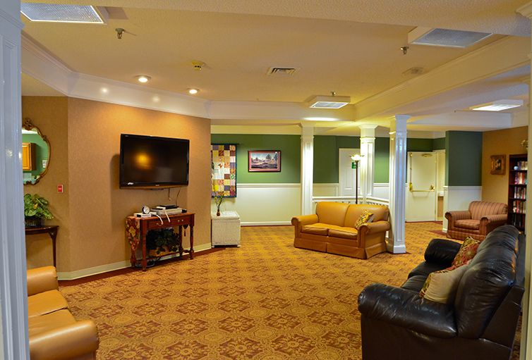 A cozy living room with a sofa, TV, and warm lighting.