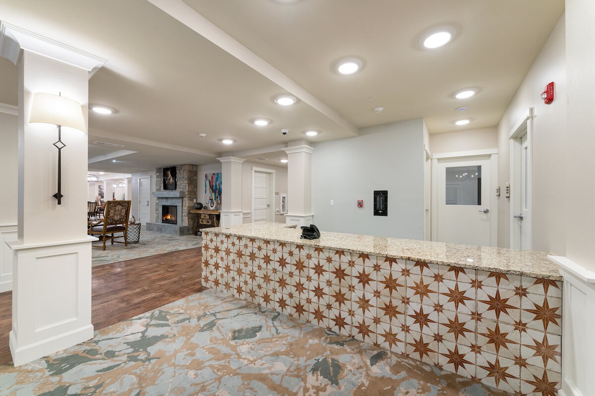 A modern reception area featuring decorative tiles and contemporary lighting.