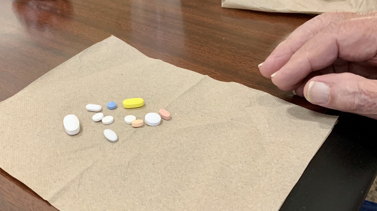 Various pills placed on a napkin on a table.