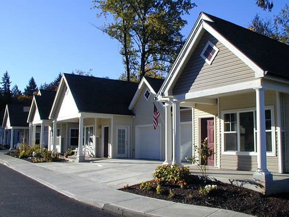 A row of suburban houses with well-maintained exteriors on a sunny day.