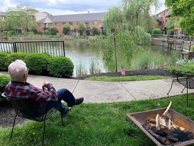 Relaxing by the fire pit with a view of the peaceful lake.