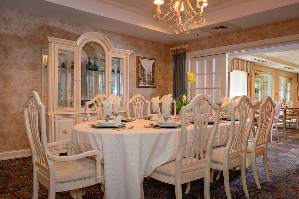 Elegant dining room with a beautifully set table and chandelier.