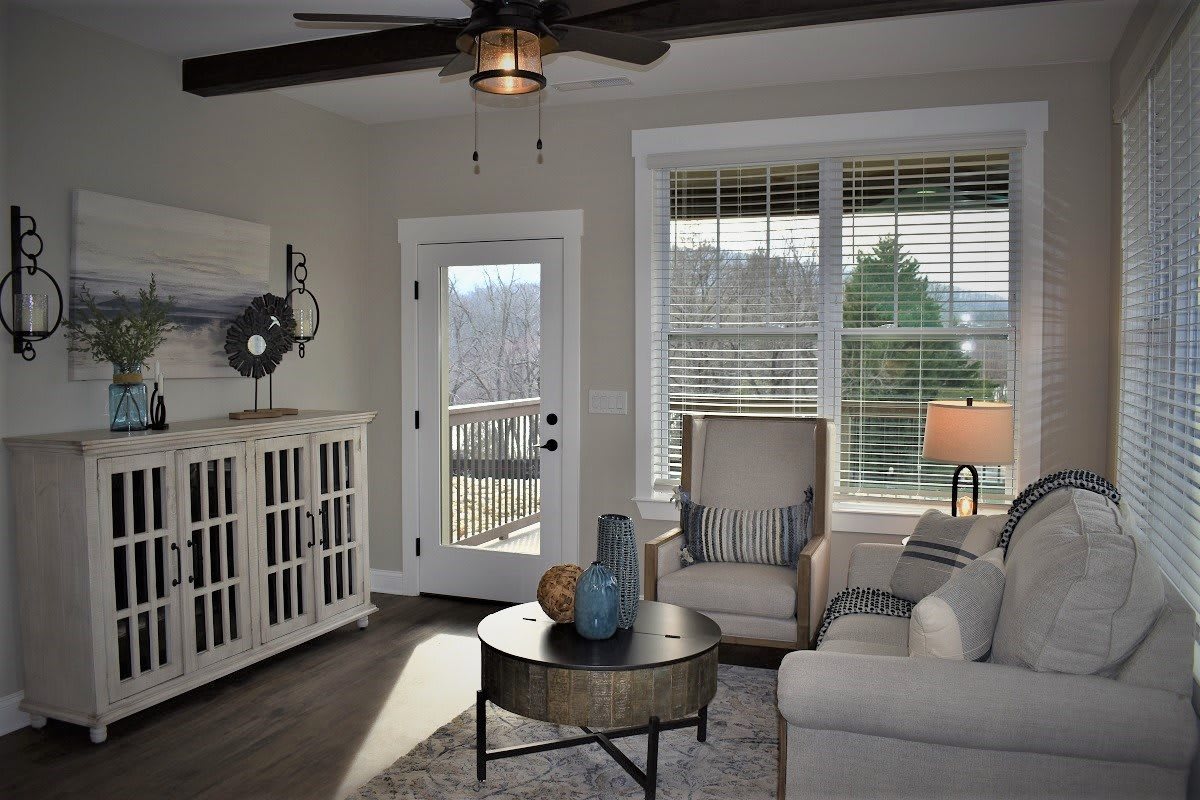 A cozy living room featuring comfortable seating and abundant natural light.