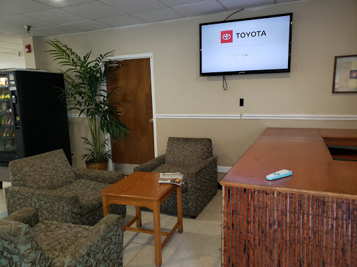 A cozy waiting area featuring comfortable seating and a TV screen.