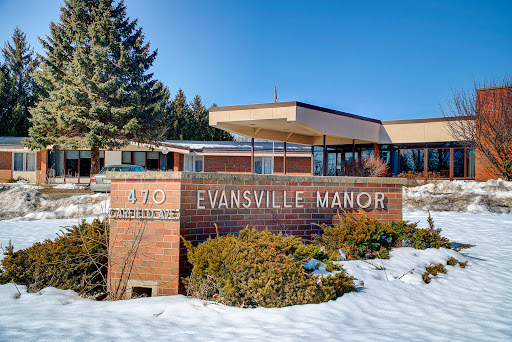 Evansville Manor, a healthcare facility, surrounded by snow in winter.