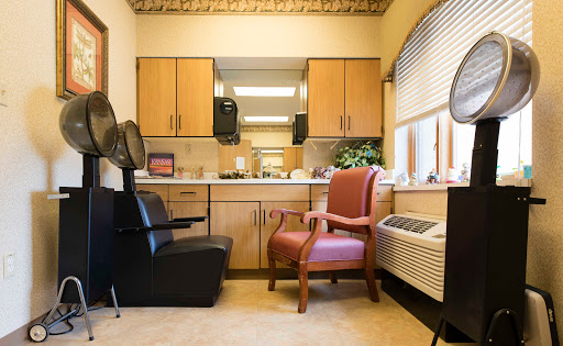 A cozy hair salon waiting area featuring a mix of seating and functional space.