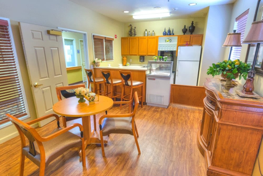A cozy kitchen and dining area with wooden furnishings and modern appliances.