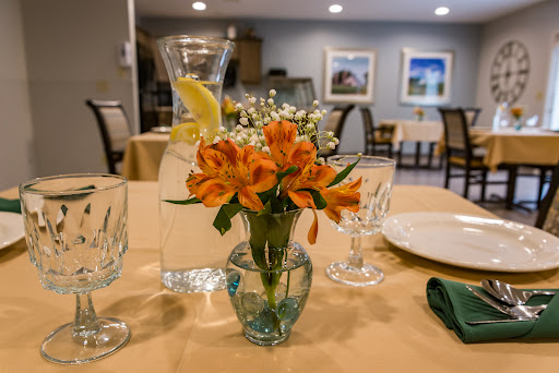 A beautifully arranged dining table featuring a vibrant floral centerpiece.