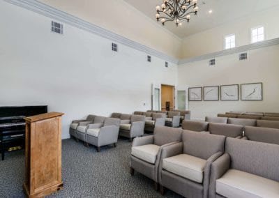 A spacious interior with arranged seating and elegant lighting.