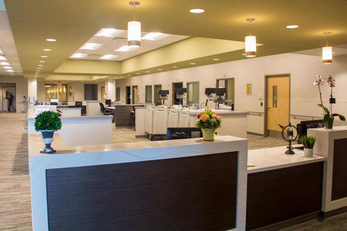 A modern office reception area with desks and bright lighting.