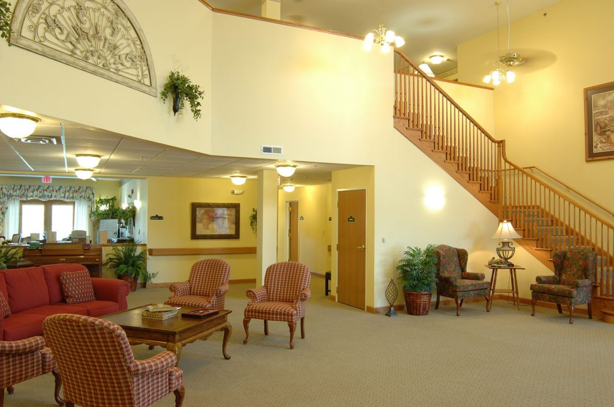 A cozy lobby area featuring comfortable seating and a staircase.