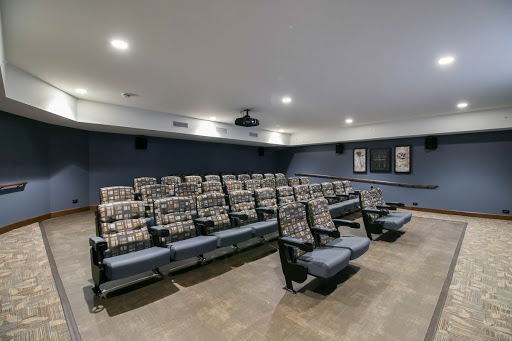 A modern home theater setup featuring comfortable seating and a projector.