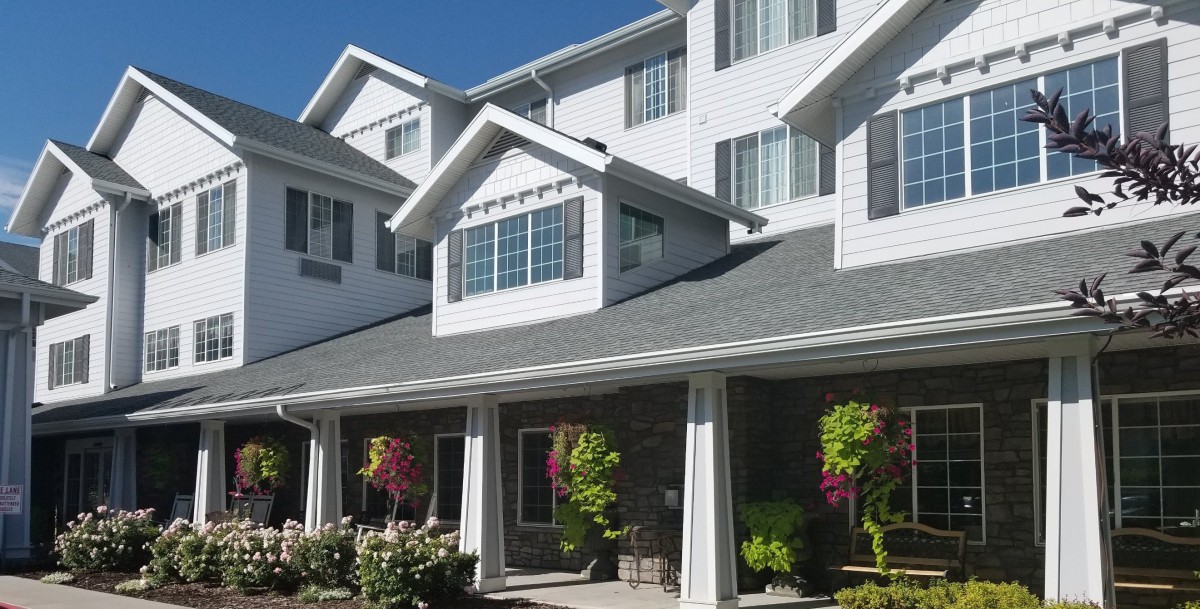 A multi-story residential building with a landscaped garden.
