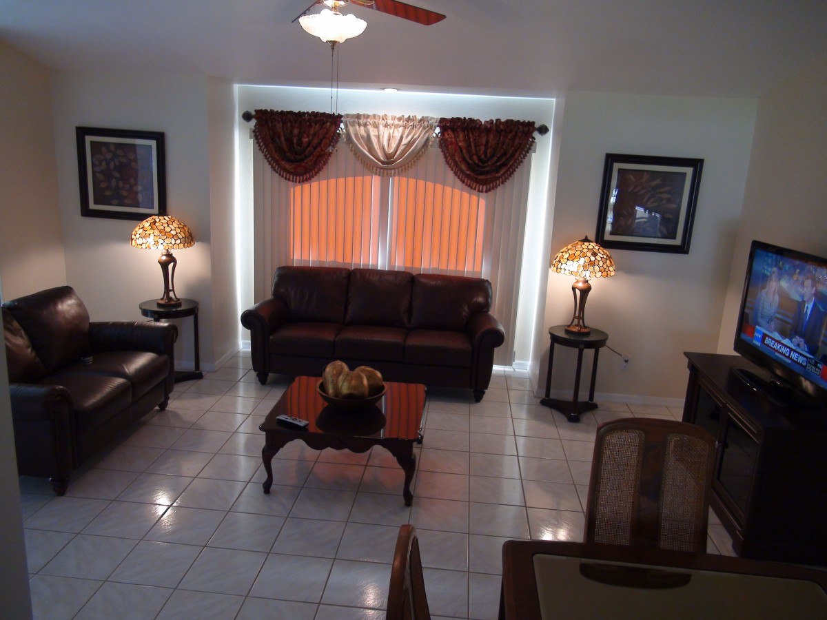 A well-decorated living room featuring a sofa, coffee table, and elegant lighting.