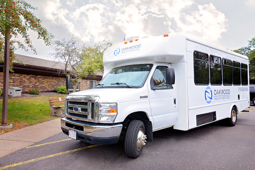 A white Ford bus parked on the street, designed for transportation.