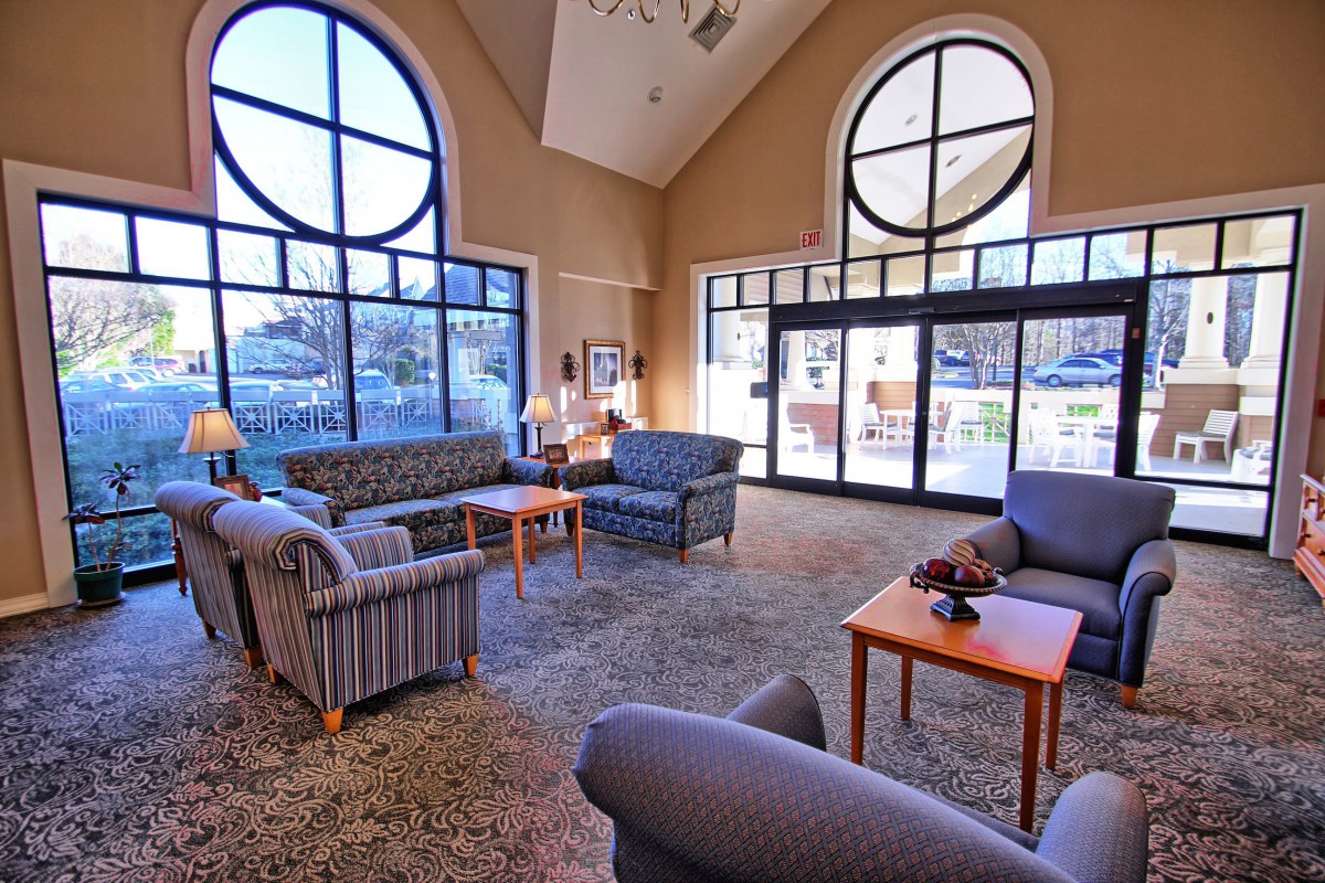 A cozy lobby with large windows, comfortable sofas, and a warm ambiance.