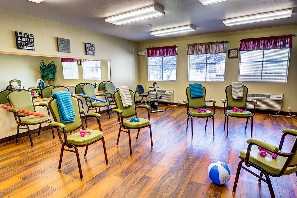 A community exercise room with chairs arranged in a circle, ready for group activities.