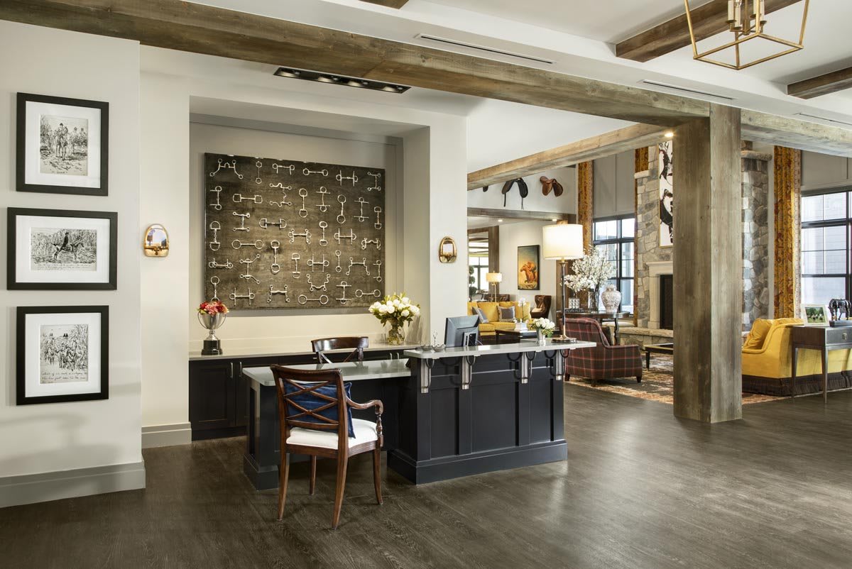 Modern office reception area with industrial design elements and artwork on the wall.